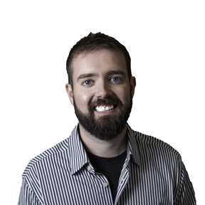 Headshot of man with brown hair and beard wearing striped shirt. Dillsboro Loan Officer, Alec Lauber.